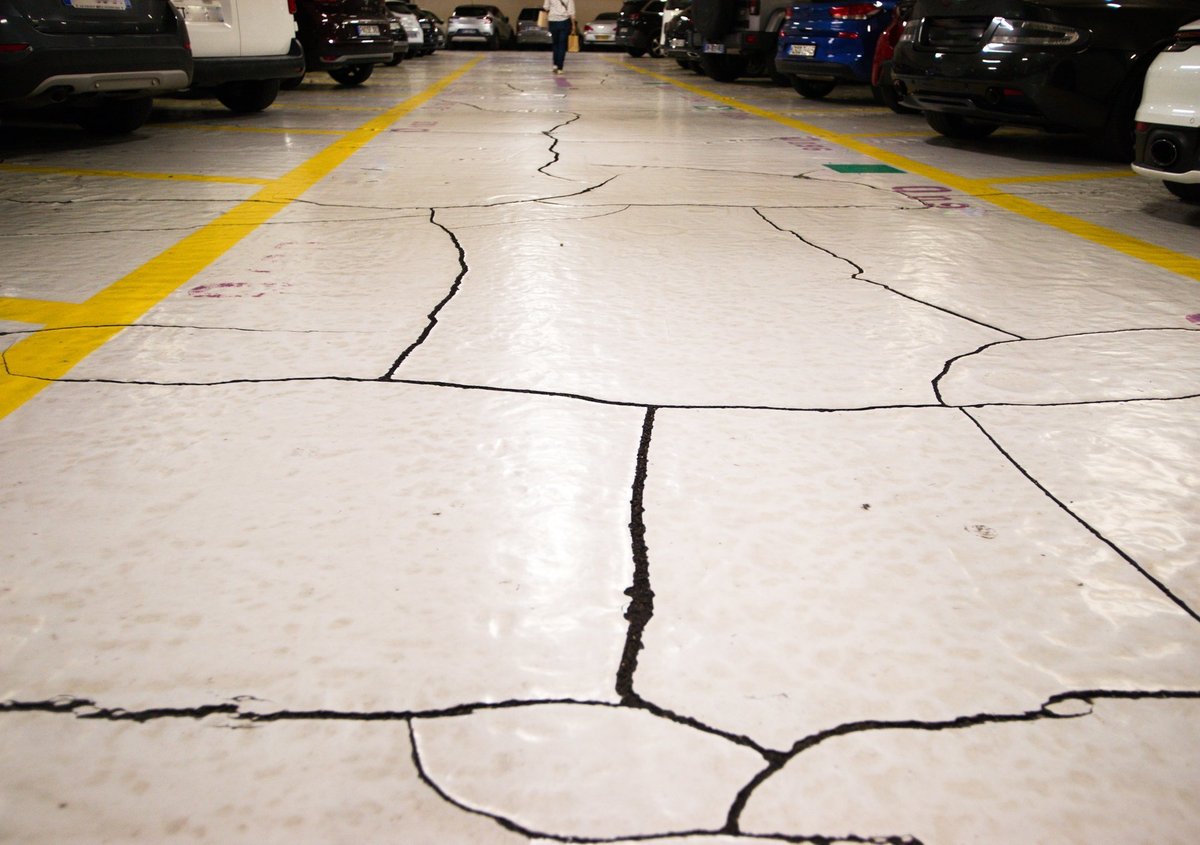 Cracked and worn concrete garage floor surface showing damage that signals it is time for a new coated floor