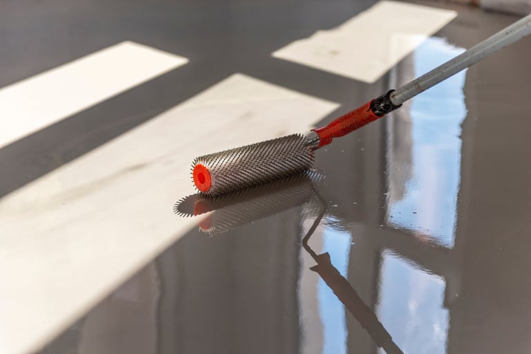 Needle roller for self-leveling floors showing professional floor leveling technique
