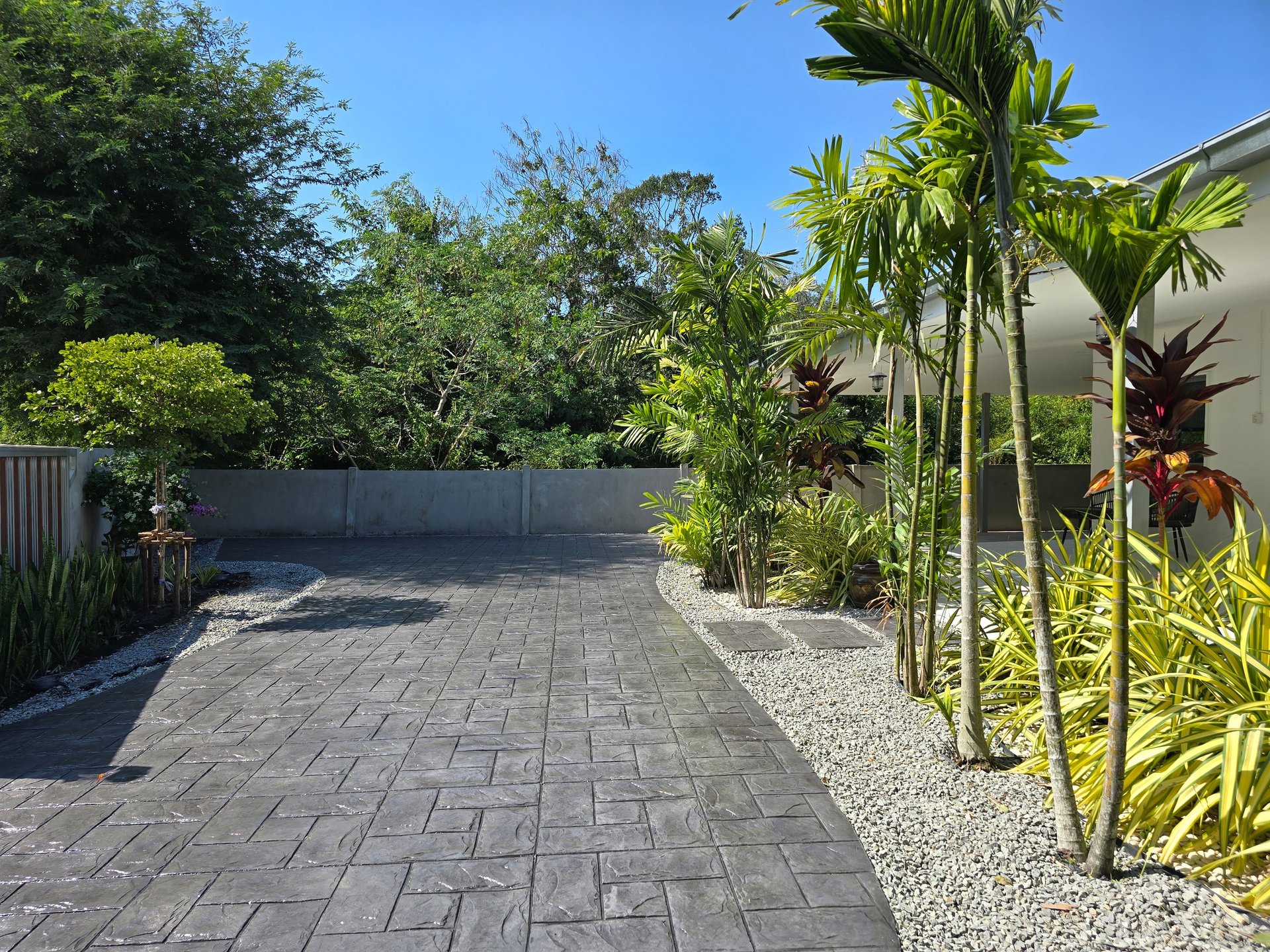 Beautiful stamped concrete pathway through vibrant plants