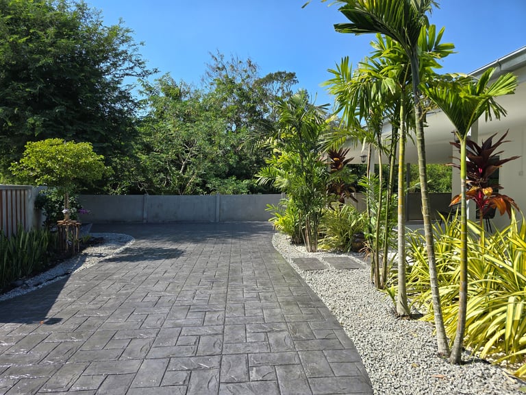 Beautiful stamped concrete pathway through vibrant plants
