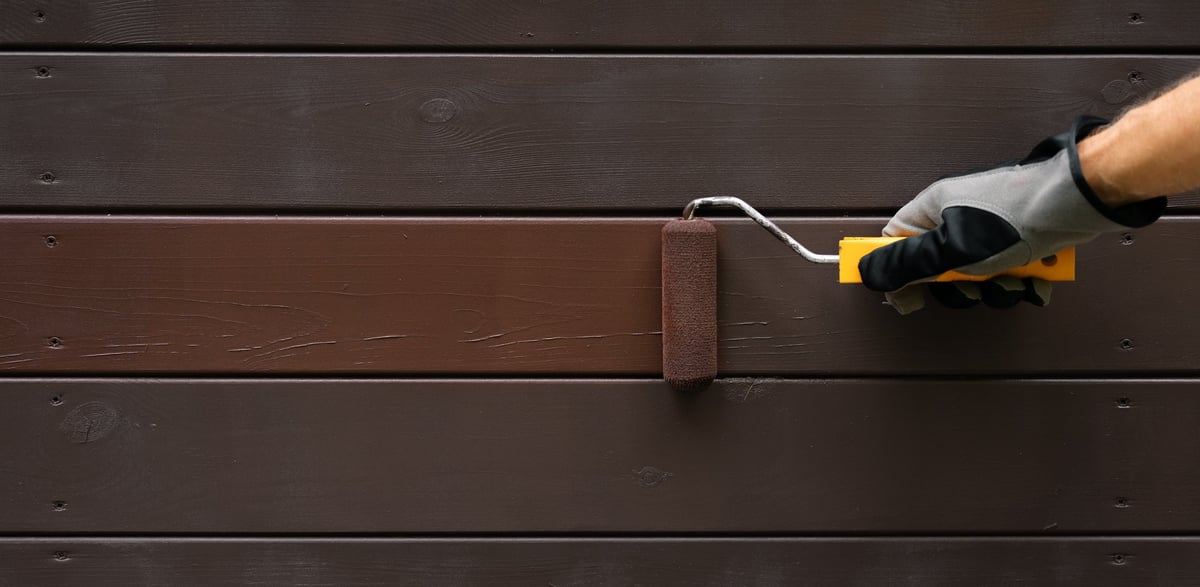 Professional painter painting house exterior in coastal Florida