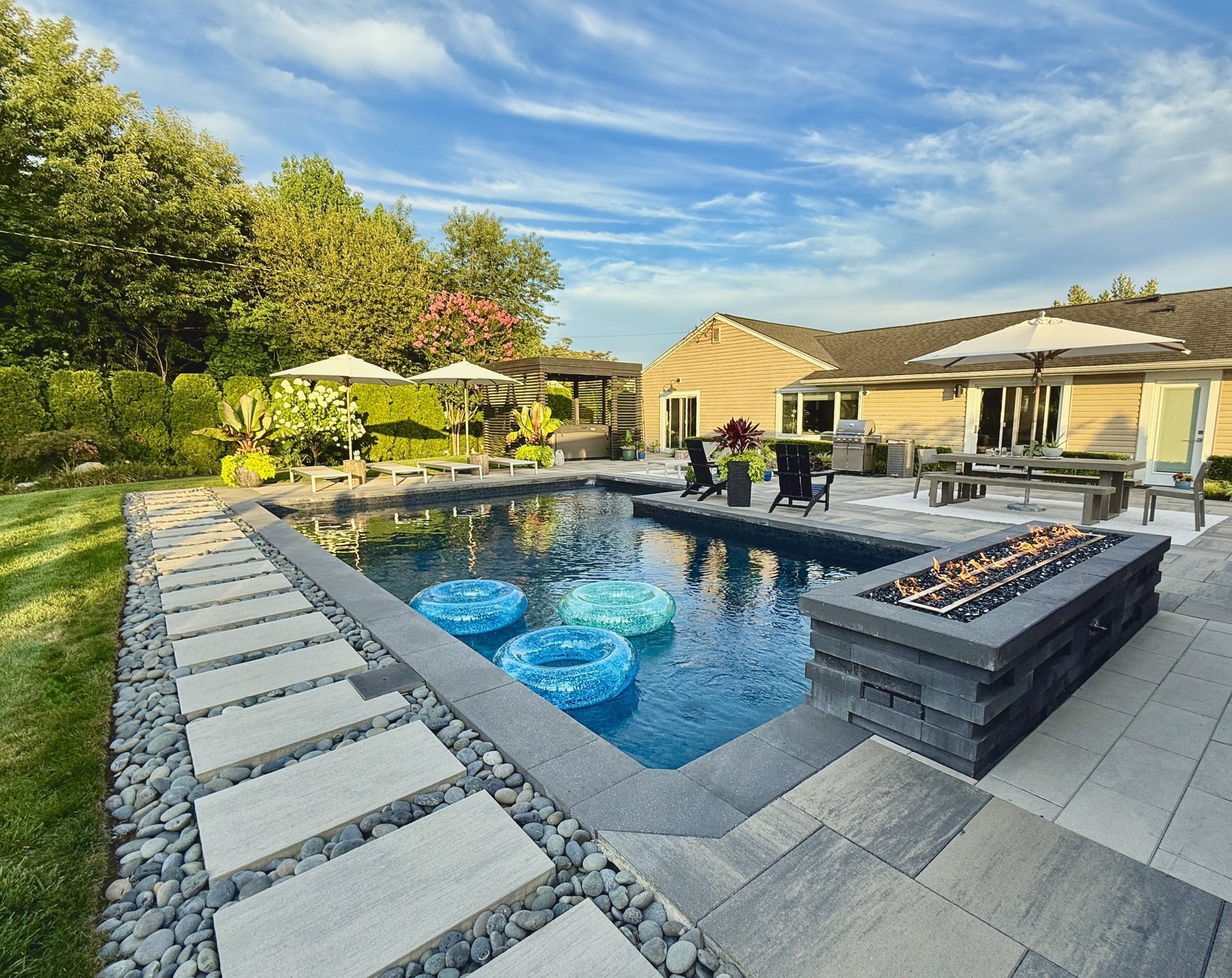 Hotel resort style outdoor living space with furniture